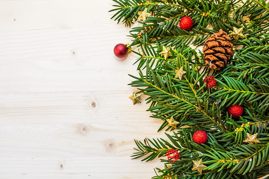 Christmas Pine Branches with Ornaments on White Wood