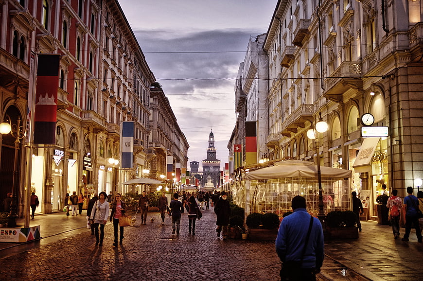 Milan City Center Street Scene at Dusk with Pedestrians