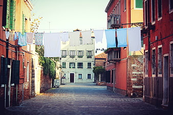 Colorful Venetian alley with laundry hanging on a line
