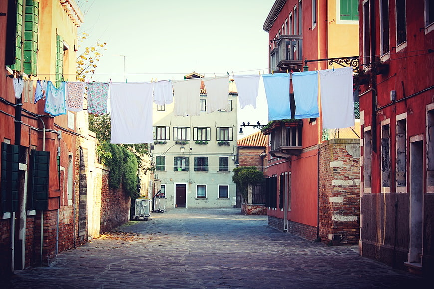 Colorful Venetian alley with laundry hanging on a line