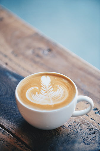 Latte Art Coffee Cup on Rustic Wooden Table