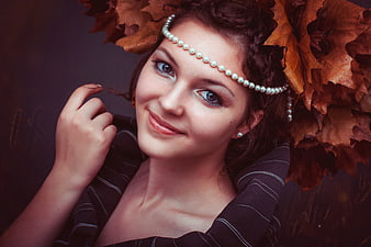 Woman with pearl headband and autumn leaves