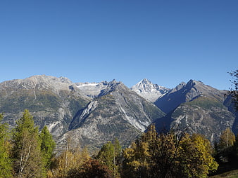 Majestic Swiss Alps Mountain Range with Autumn Forest