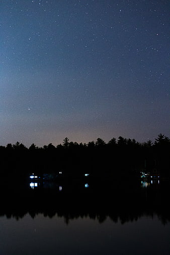 Starry Night Sky Over Lake With Tree Silhouettes