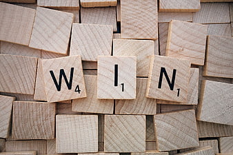 Wooden Scrabble Tiles Spelling WIN on Background