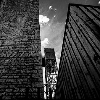 Black and white low angle view of industrial architecture and sky