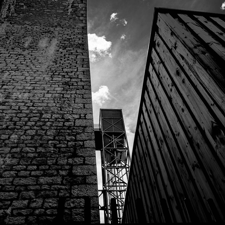 Black and white low angle view of industrial architecture and sky