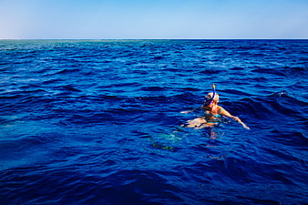 Woman Snorkeling in Deep Blue Ocean Water