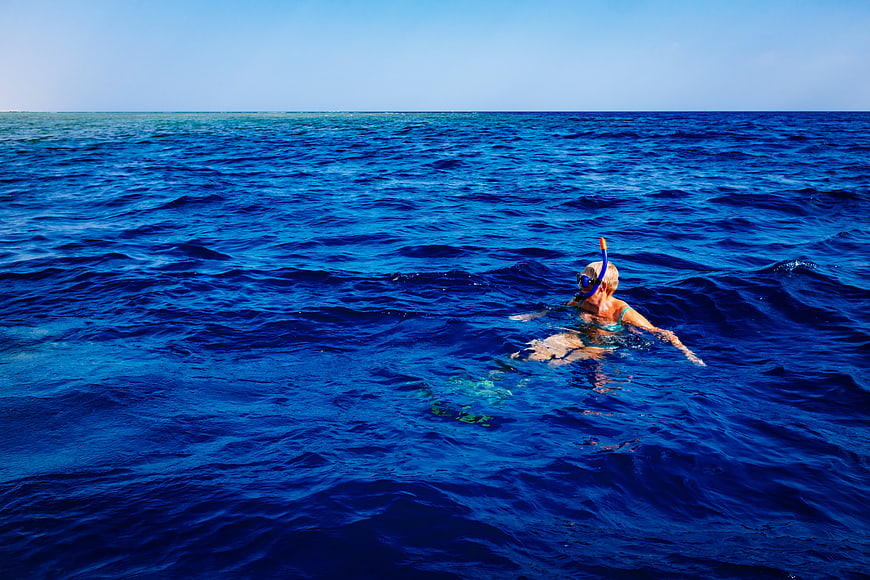Woman Snorkeling in Deep Blue Ocean Water