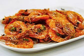 Savory Fried Prawns with Garlic and Peppercorns on White Plate