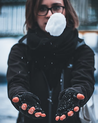 Woman Throwing Snowball in Winter Jacket