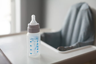 Empty Baby Bottle on White High Chair Tray