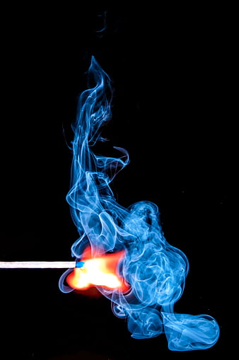 Burning Match with Blue Smoke on Black Background