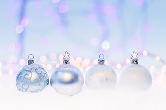 Frosted Blue and White Christmas Baubles on Snow with Bokeh