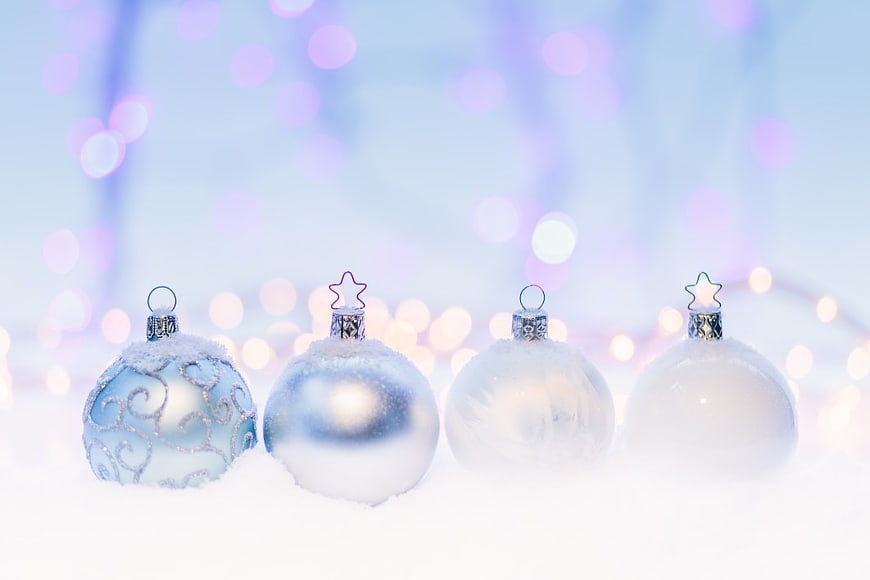 Frosted Blue and White Christmas Baubles on Snow with Bokeh
