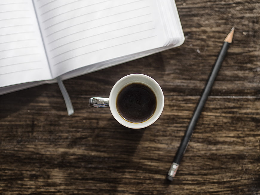Top View Coffee Cup Notebook Pencil On Rustic Wooden Desk