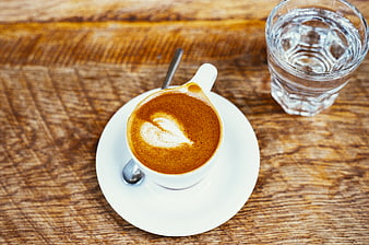 Top View Cappuccino with Latte Art on Wooden Table