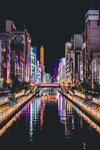 Night view of Osaka canal with neon lights and reflections