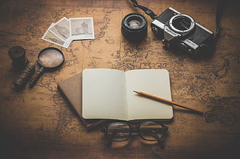 Vintage Travel Essentials on Old World Map Background