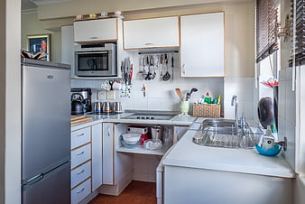 Bright Contemporary Kitchen Interior With White Cabinets And Stainless Steel Appliances