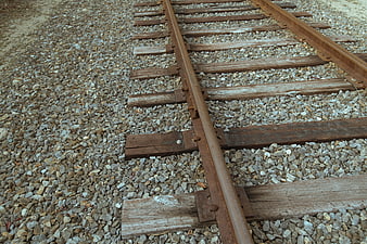 Rusty Train Tracks on Gravel Ballast Background
