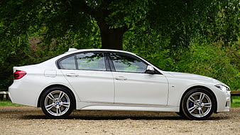 White BMW 3 Series Sedan Side Profile in Nature