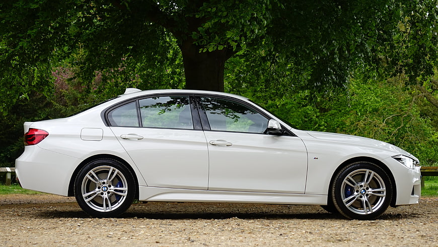 White BMW 3 Series Sedan Side Profile in Nature