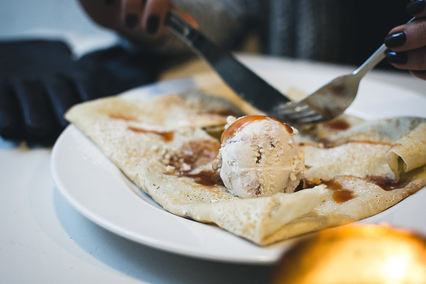 Close-up of crepe with ice cream and caramel sauce