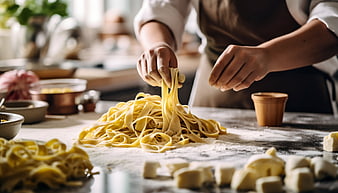 Hands making fresh homemade pasta in a rustic kitchen