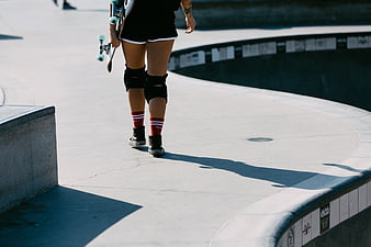 Skateboarder Walking Away at Concrete Skate Park