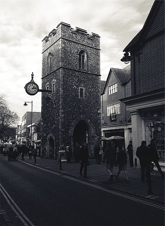 Black and white street scene with historic stone clock tower