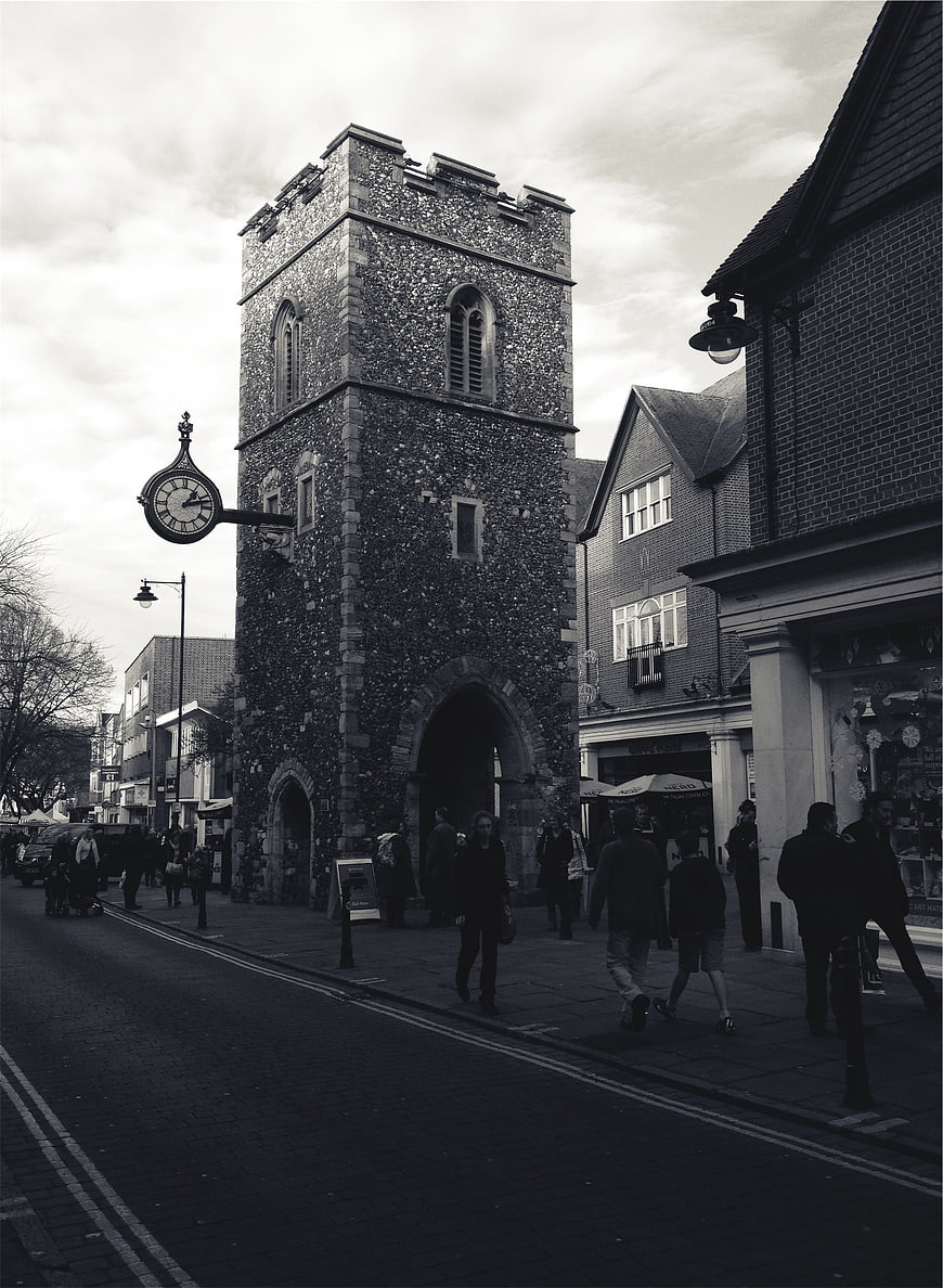 Black and white street scene with historic stone clock tower