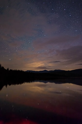Starry Night Sky Reflection on Calm Lake with Mountains