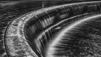 Black and white long exposure curved waterfall dam