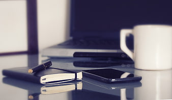 Modern workspace with laptop, notebook, and coffee cup