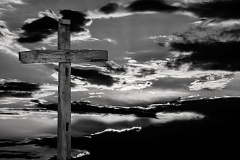 Dramatic Wooden Cross Against Stormy Black and White Sky