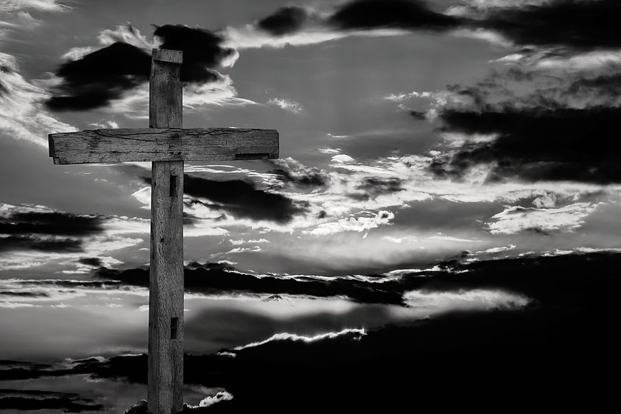 Dramatic Wooden Cross Against Stormy Black and White Sky