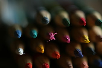 Close-up of colorful pencil tips arranged in a grid