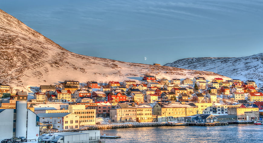 Colorful Coastal Town in Snowy Winter Landscape