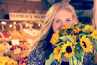 Happy Woman Holding Sunflowers at Farmers Market