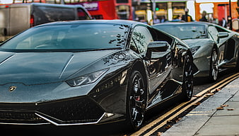 Black Lamborghini Huracan and Silver Aventador Parked on City Street