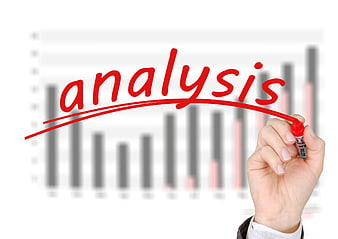 Hand writing analysis on glass with business chart background
