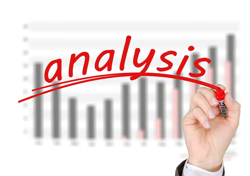 Hand writing analysis on glass with business chart background