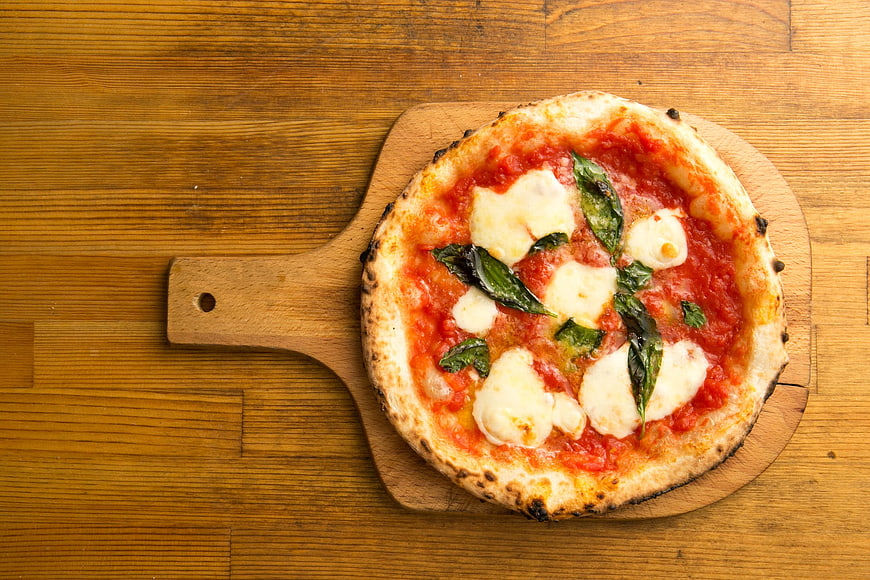 Fresh Margherita Pizza on Wooden Board Top View