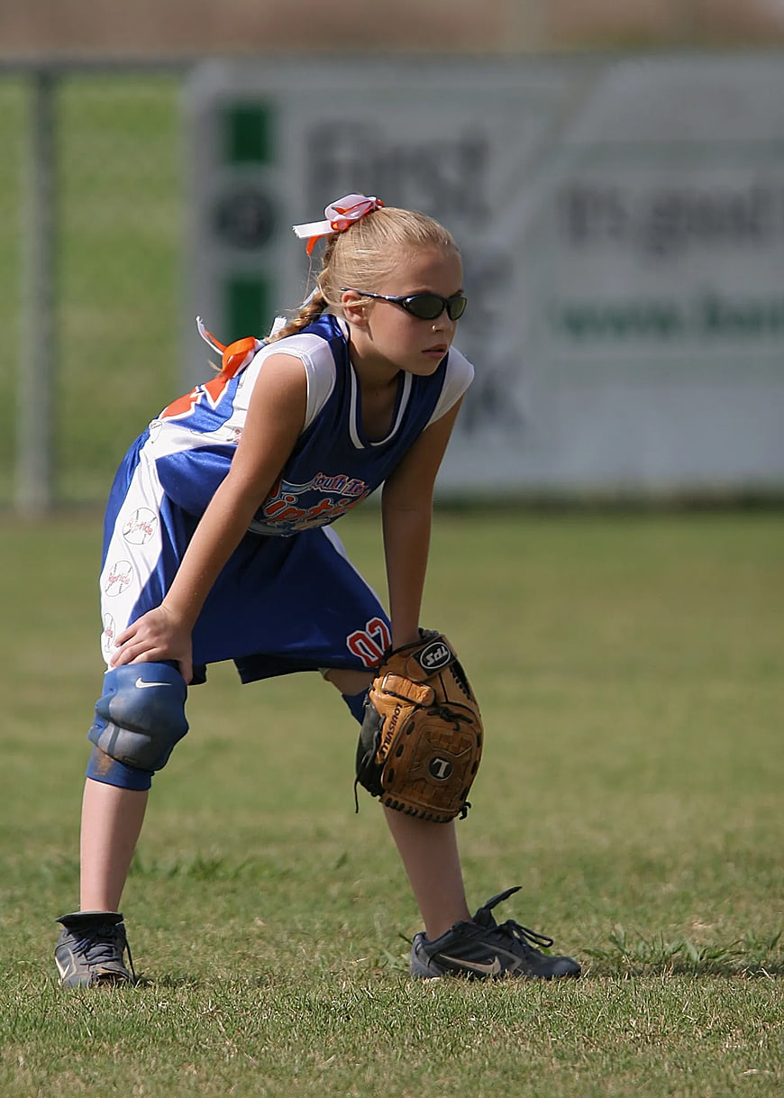 Young Girl Softball Player in Ready Stance on Field