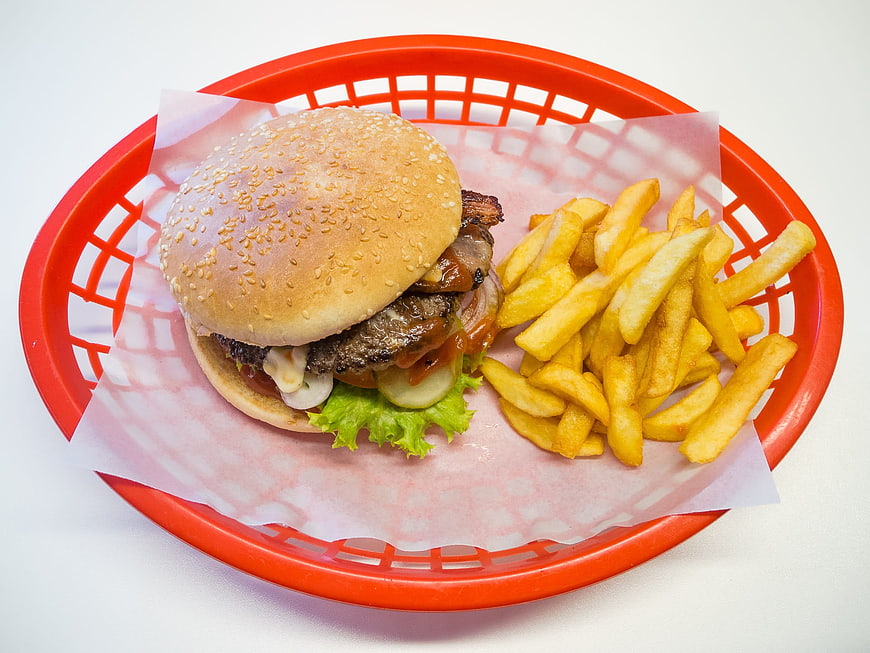 Cheeseburger with French Fries in Red Plastic Basket