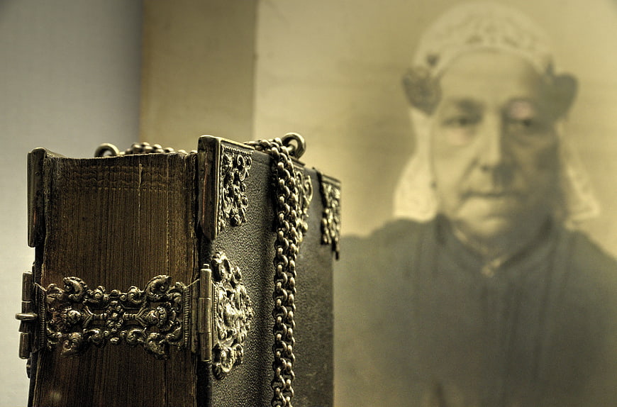 Antique leather bible with silver chains and vintage portrait