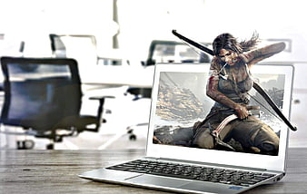 Tomb Raider character emerging from laptop screen in modern office