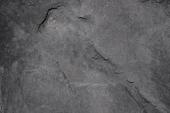 Dark gray rock texture background with cracks