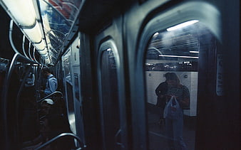 Candid Film Photo of Commuters in a Dimly Lit Subway Car